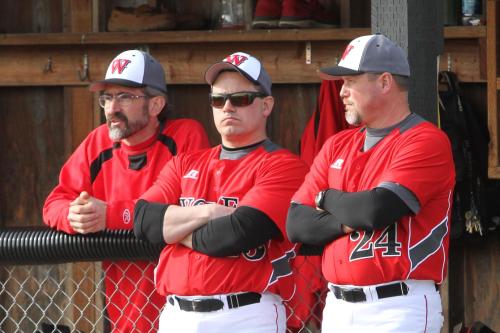 Wolf assistant coach Chris Tumblin (middle) is smiling on the inside.