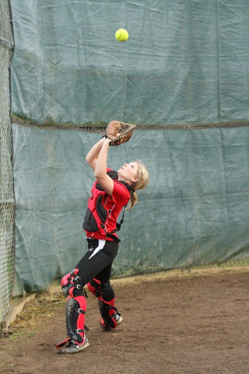 Wolf catcher Breeanna Messner prepares to haul in a foul ball.