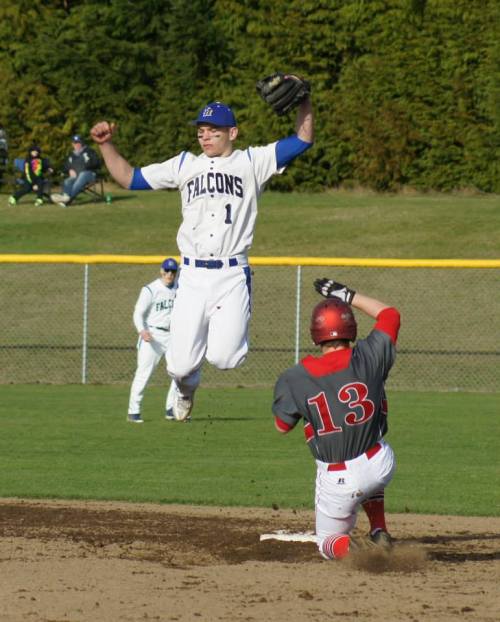 Ricky Muzzy goes airborne as Coupeville's Korbin Korzan slides into the bag. (Shelli Trumbull photo)