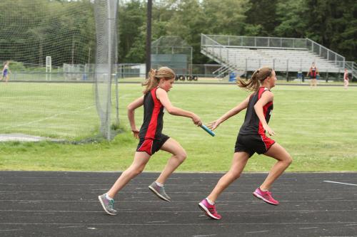 Reed Richards (left) hands the baton to Roberts in the 4 x 100 relay.