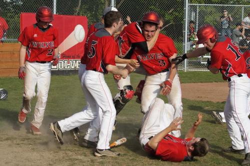 Ben Etzell gets mobbed at home after scoring the game-winning run. (Shelli Trumbull photo)