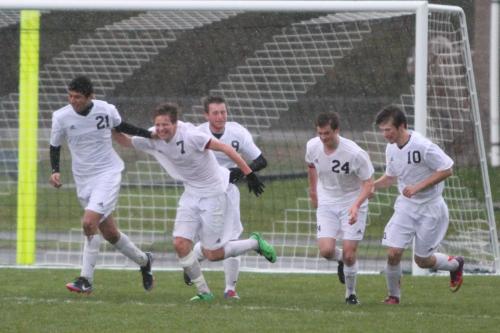 The Wolves celebrate a huge goal in the rain. Left to right are Abraham Leyva, Zane Bundy, Jason Knoll, Donley and Cameron Boyd.