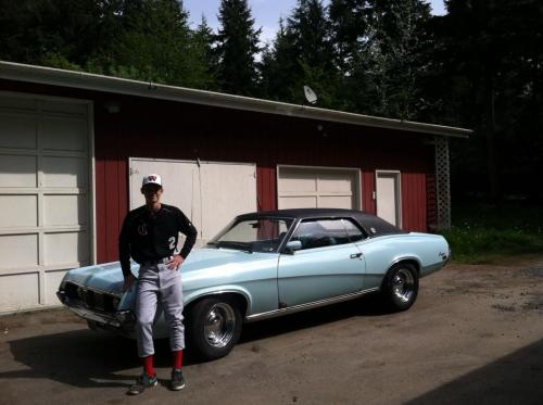 Jake Davis with his two loves -- baseball and cars.