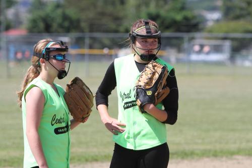 Lauren Rose (left) offers some tips, while McGranahan shoots her best stink-eye at the batter.