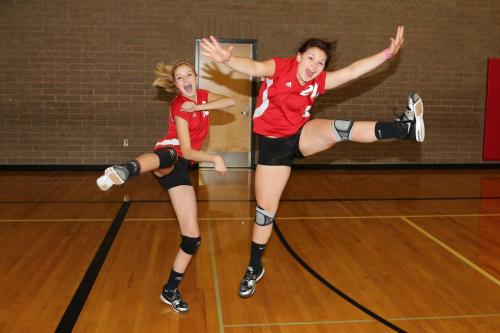 Kacie Kiel (left) and Madeline Strasburg get pumped up before their volleyball match.