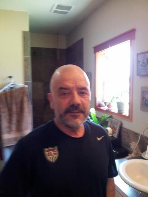 Former CHS boys' soccer coach (and professional player) Paul Mendes sports a shaved head as he supports his national team, the host Brazilians. (Heidi Hennessey photo)