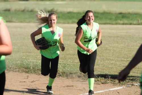 Hope Lodell (left) and Mia Littlejohn sprint in to join the celebration after winning districts.