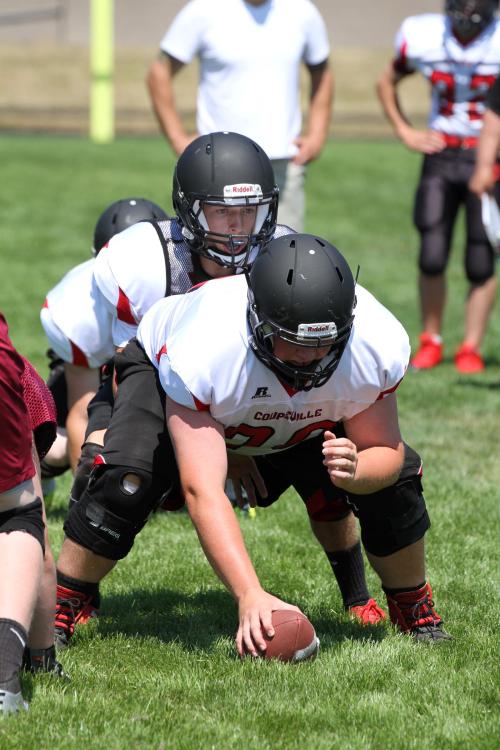 Wolf QB Joel Walstad waits for the snap from Carson Risner. (John Fisken photos)