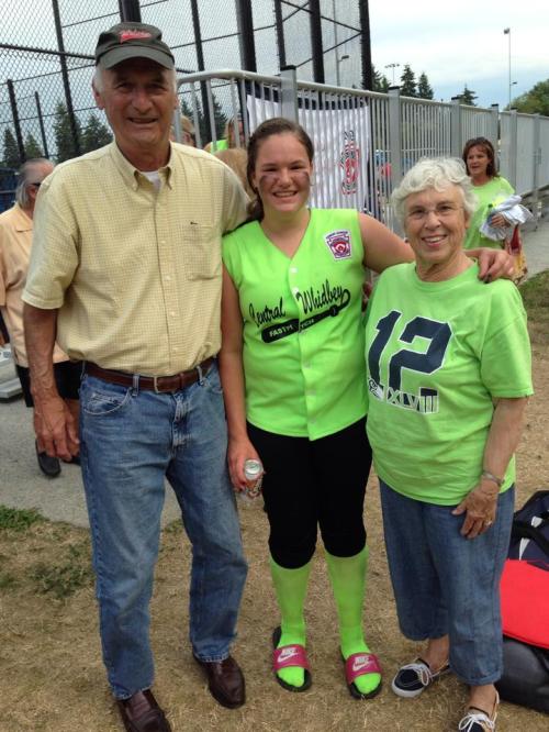 Sarah Wright, who bashed a homer over the fence in game two, poses with grandparents Ron and Gretchen Smith. (Monroe photo)