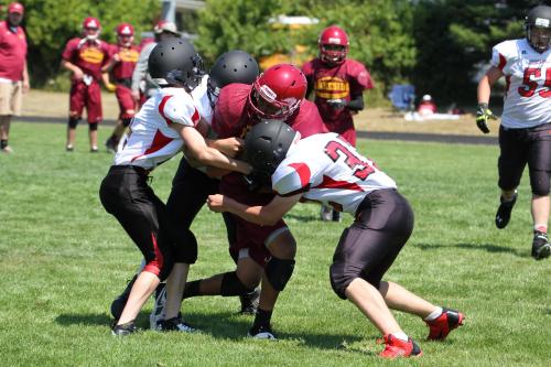 Coupeville's second-string works on team tackling, bringing three men down hard on a runner.