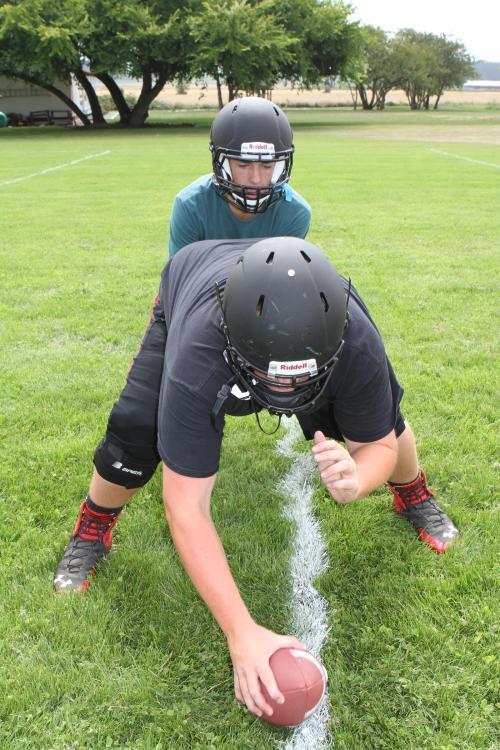 Wolf QB Joel Walstad and center Carson Risner work on their timing. (John Fisken photos)