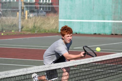 Sophomore John McClarin goes low for a volley. (John Fisken photos)