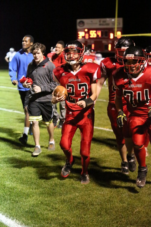 Raymond Beiriger (with ball) comes off the field after scoring against Chimacum. (John Fisken photos)