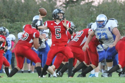 Wolf QB Joel Walstad stands tall in the pocket as 300-pound South Whidbey lineman Pierce Jackson tries to break through to harass him. (Steve Smith photo)