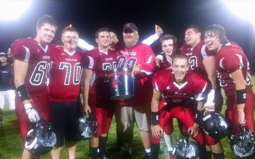 Wolf seniors celebrate with coach Tony Maggio. (Shawn Walstad photo)