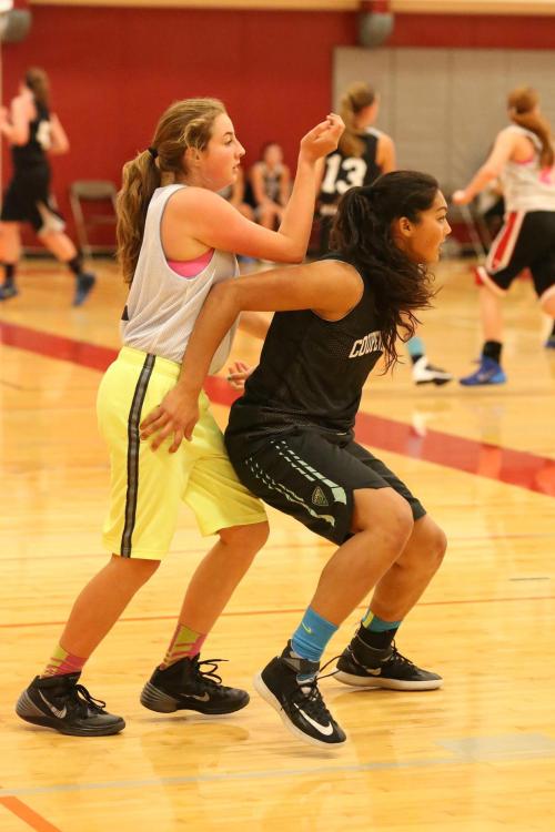 Makana Stone (right) makes dang sure her player isn't getting to any rebounds.