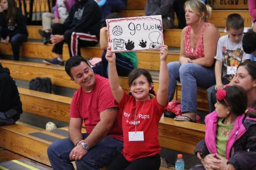 A Wolf Buddie displays the sign she made to support