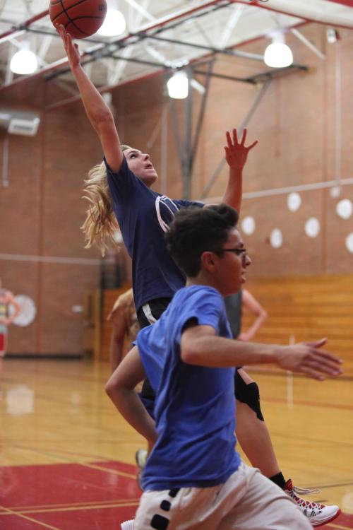 Wynter Thorne flies in for two, while a defender runs for cover.