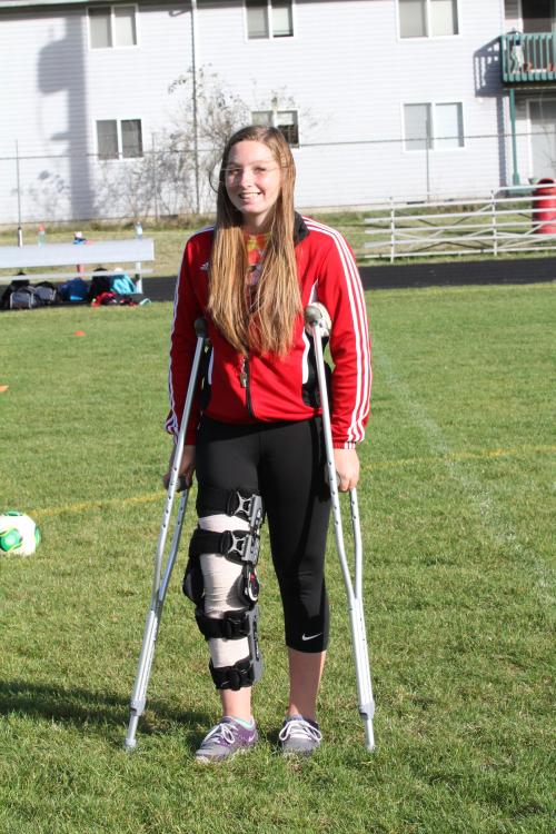 A blown-out knee is preventing Jenn Spark from playing, but not cheering.
