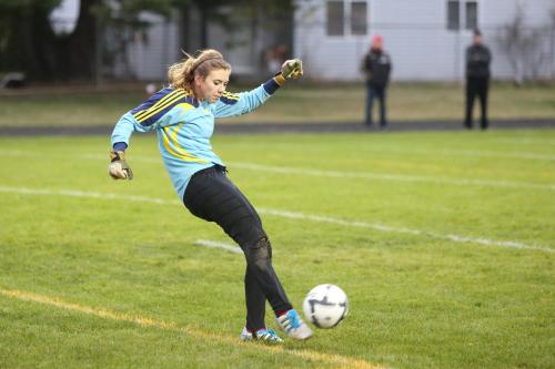 Wolf goalie Julia Myers blasts the ball out of the danger zone. (John Fisken photo)
