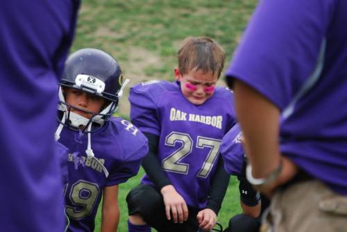 Logan Downes (27) and teammates absorb the first loss of their football careers. (Pat Kelley photos)
