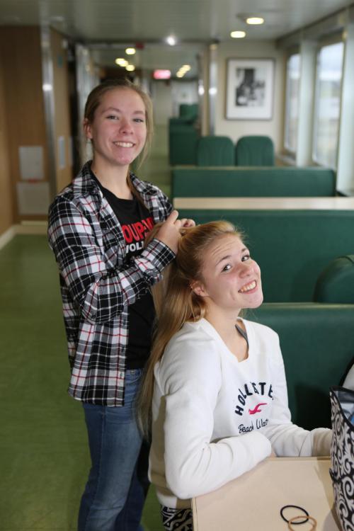 Lauren Rose works on fellow spiker Hope Lodell's hair during the trip. (John Fisken photos)
