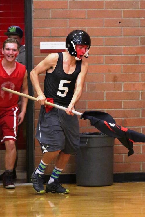 Joel Walstad (with flag) and Gabe Wynn come charging out of the locker room ready to cheer.