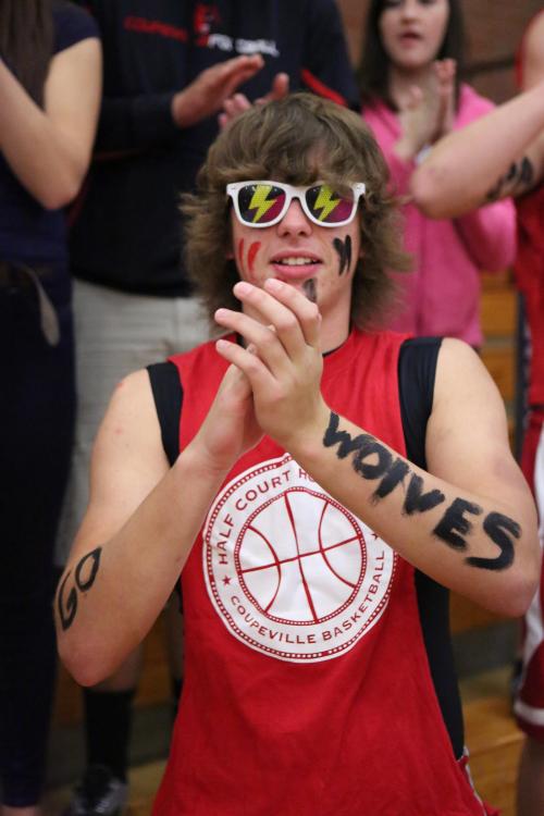 Wolf football player Isaac Vargas leads the cheering section for his school's volleyball squad. (John Fisken photos)