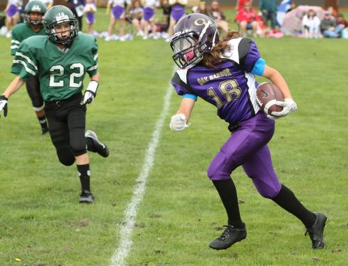 Gabe flies for yardage while playing youth football in Oak Harbor. (John Fisken photos)