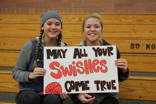 Wolf super fans Abby Parker (left) and Hope Lodell master the art of wordplay.