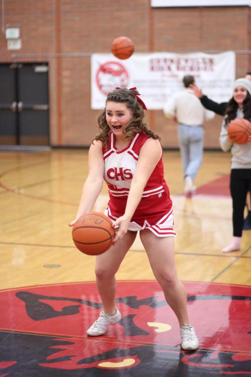 Wolf cheerleader Camilla Rische lets fly during the halftime half-court shot competition. (John Fisken photos) 