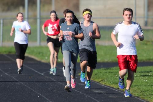 Lauren Bayne, Mitchell Losey (hedband) and Grey Rische come thundering down the back stretch.