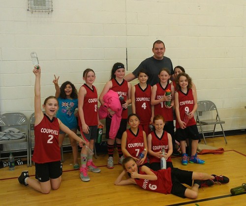 Coupeville's 5th/6th grade squad celebrates with coach Lark Gustafson. (Katy Wells photo)