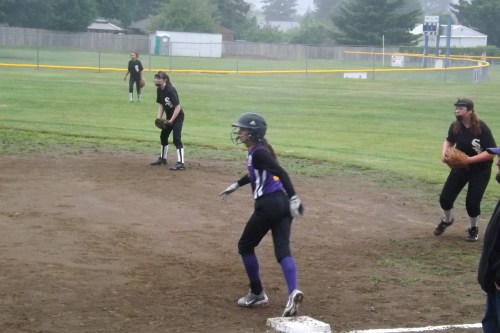 An Oak Harbor runner tries to creep away from first.