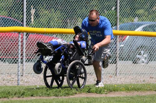 A dad and son team zing around third base and head for home.