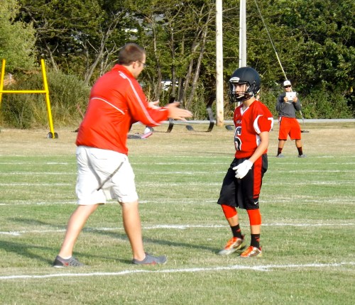 Wolf coach Brett Smedley passes on knowledge to sophomore Cameron Toomey Stout.