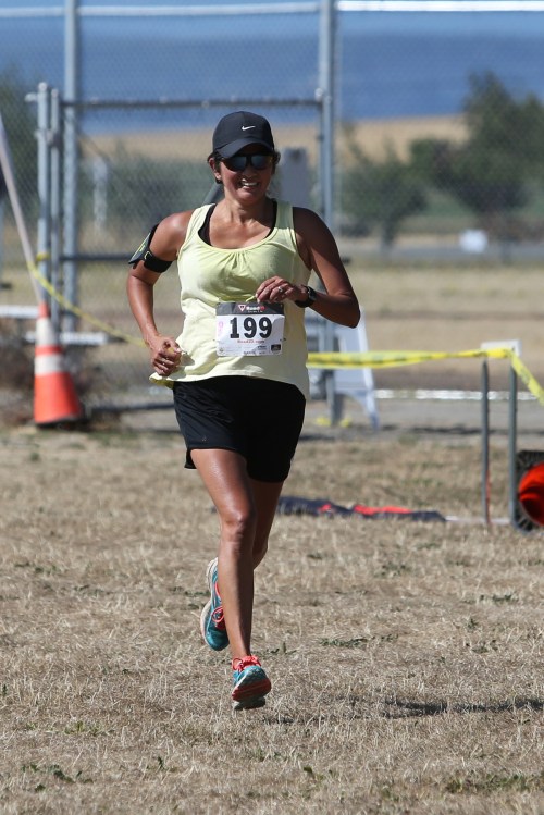 CMS track coach Elizabeth Bitting rolls to the best performance in the half marathon by a female runner from Coupeville. (John Fisken photos)
