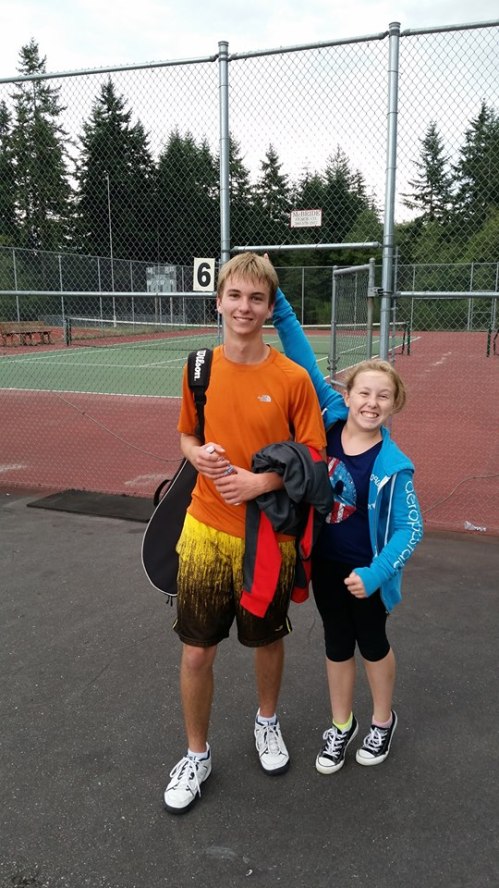 Wolf senior Connor McCormick celebrates his win at #2 singles with the president of his fan club. (Wendy McCormick photo)