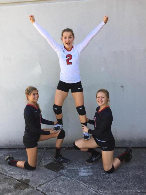 Payton Aparicio (left) and Hope Lodell give captain Valen Trujillo a boost. (Lauren Rose photo)