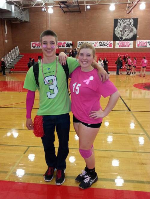 Tiffany Briscoe celebrates with Wolf gridiron star (and huge volleyball fan) Jacob martin.