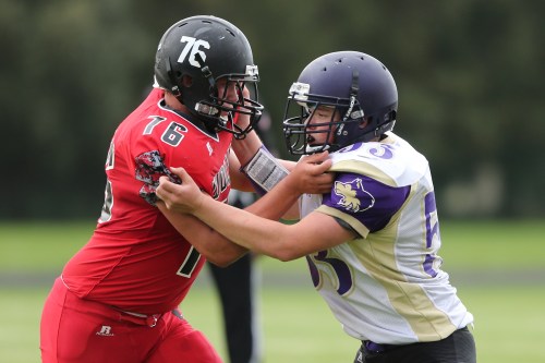 James Vidoni (76) holds the line.