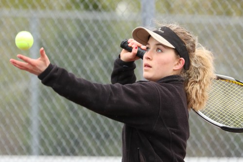Valen Trujillo serves up an ace as she rolls to a win at #1 singles.