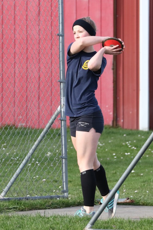 Just days after she and the Wolf girls' basketball team went to state, sophomore Allison Wenzel gets limbered up for the discus.