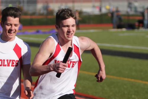 Jacob Martin (right) takes the hand-off from Gabe Eck and sprints away in the 4 x 100.