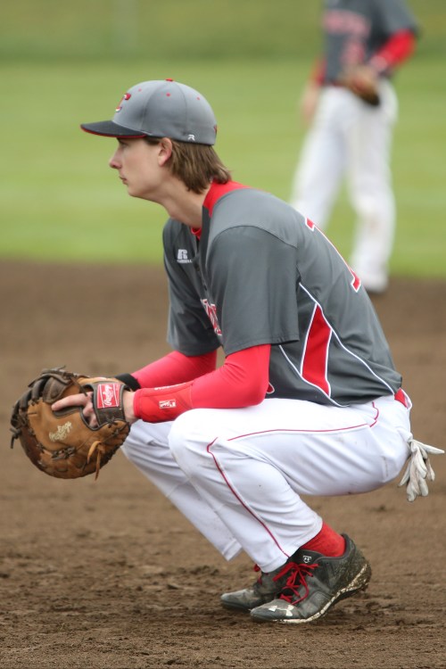 Wolf first baseman Kory Score takes a break while waiting for a pitching change. (John Fisken photo)
