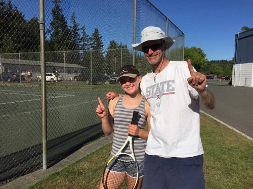 Olympic League singles champ Valen Trujillo poses with Wolf coach Ken Stange.