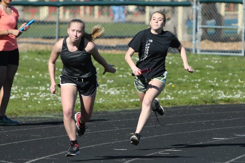 Abby Parker comes flying from behind, as Mckenzie Meyer waits for the hand-off. (John Fisken photo)