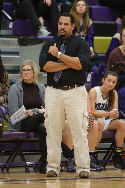 Jon Atkins patrols the sideline during an Oak Harbor High School girls' basketball game. (John Fisken photos)