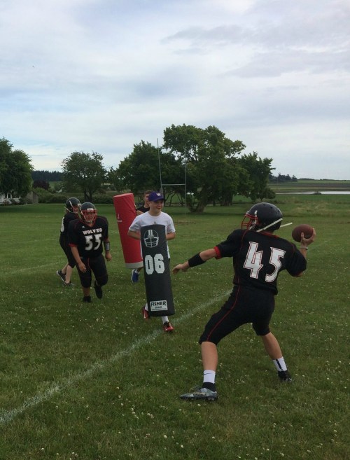 Jake Mitten rolls out to throw, as CHS QB Hunter Downes comes flying in. (Photos courtesy Bob Martin)