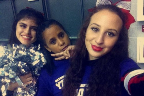 Starr and fellow Wolf cheerleaders Julie Bucio (left) and Katherine Morales hang out while waiting at a UW cheer camp.